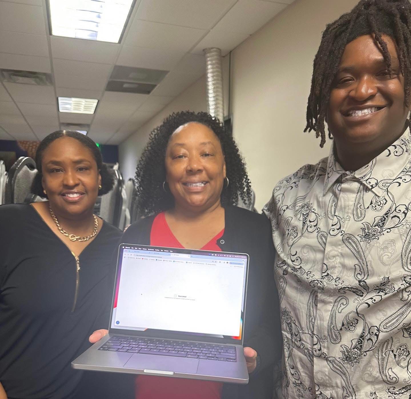 Kalisa Vaughn with clients celebrating a financial literacy milestone