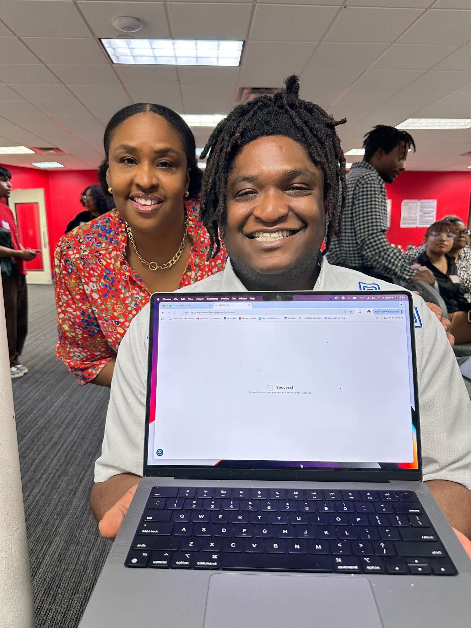 SMART Business Group member celebrating a successful funding approval on his laptop